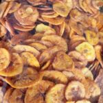 Golden-brown ripe banana chips fill a clear package, showing thin slices made from sparingly ripe bananas with a lightly sweet taste and minimal salt.